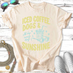Iced coffee, dogs & sunshine graphic on a cream t-shirt.