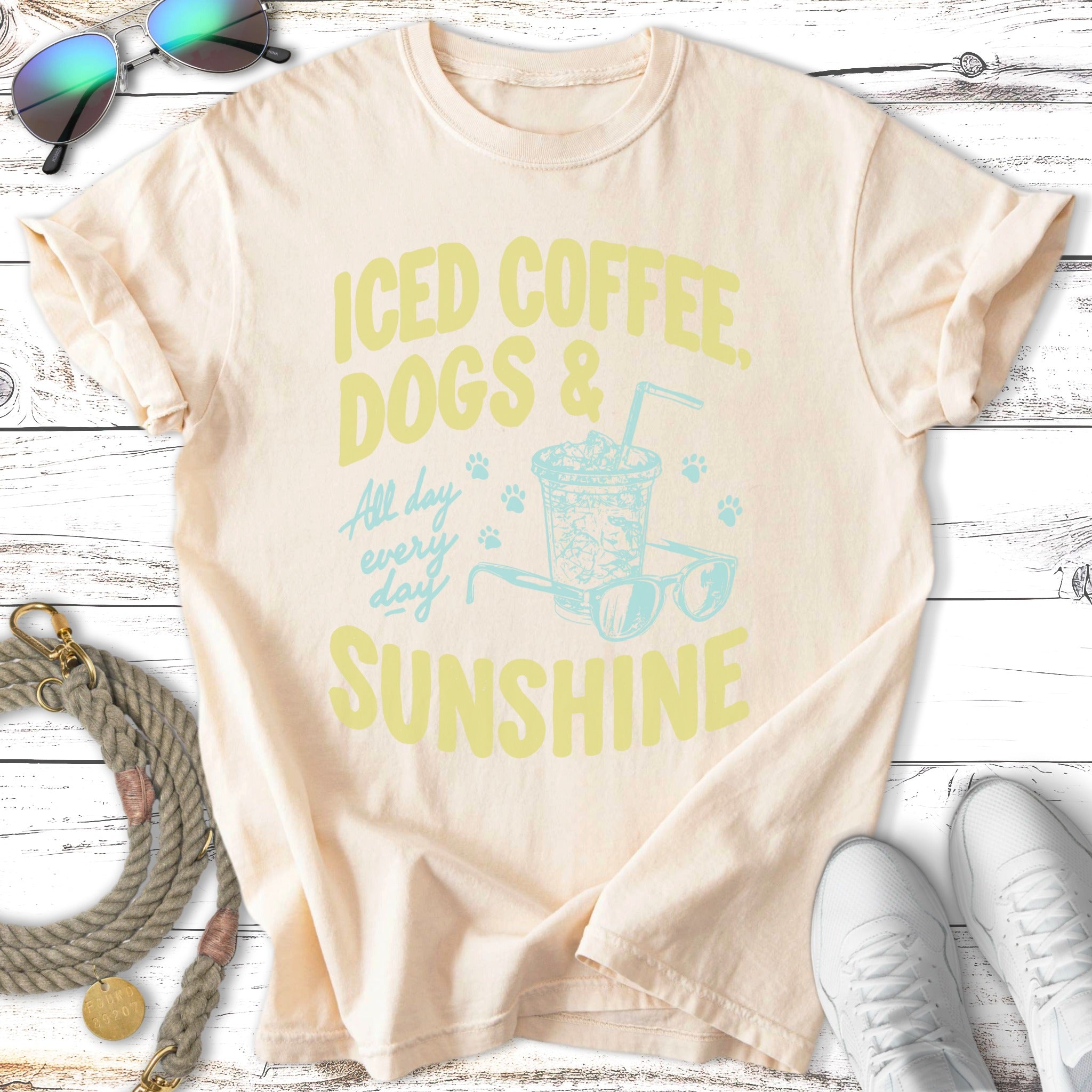 Iced coffee, dogs & sunshine graphic on a cream t-shirt.