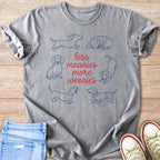 Grey t-shirt with blue line drawings of dachshunds and red text reading "less meanies more weenies."