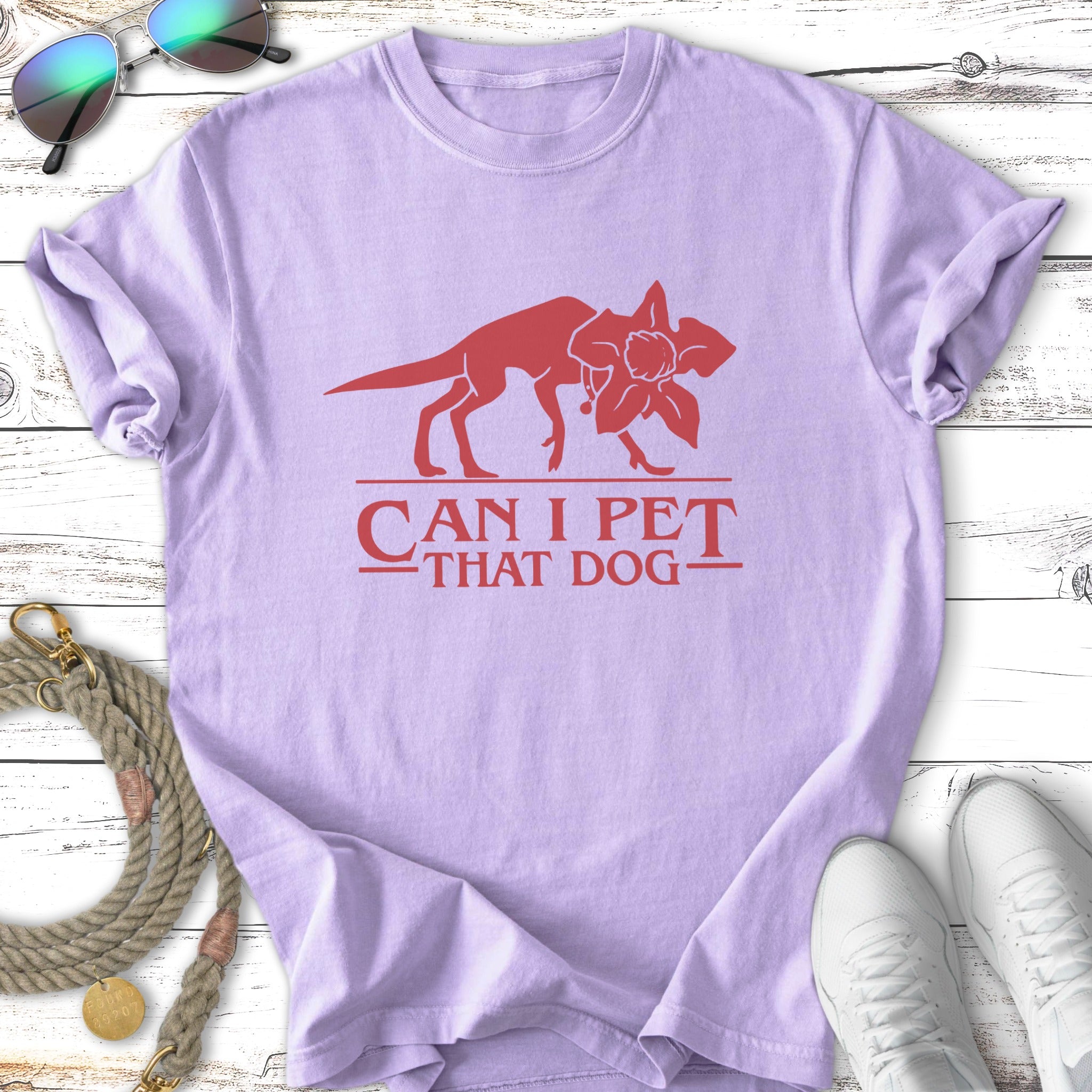 Purple t-shirt with red graphic and text "Can I Pet That Dog".