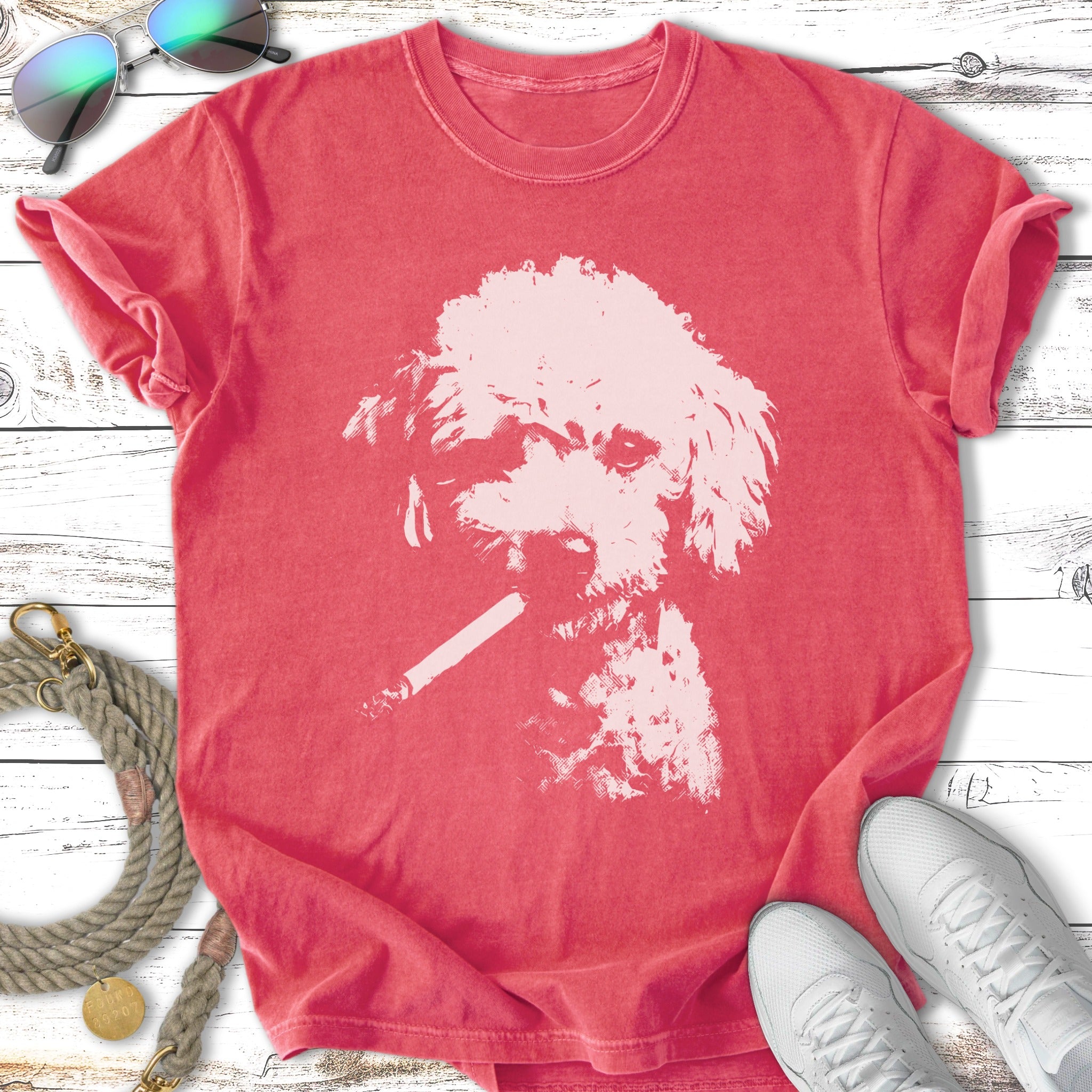 White poodle silhouette smoking a cigarette on a coral t-shirt.