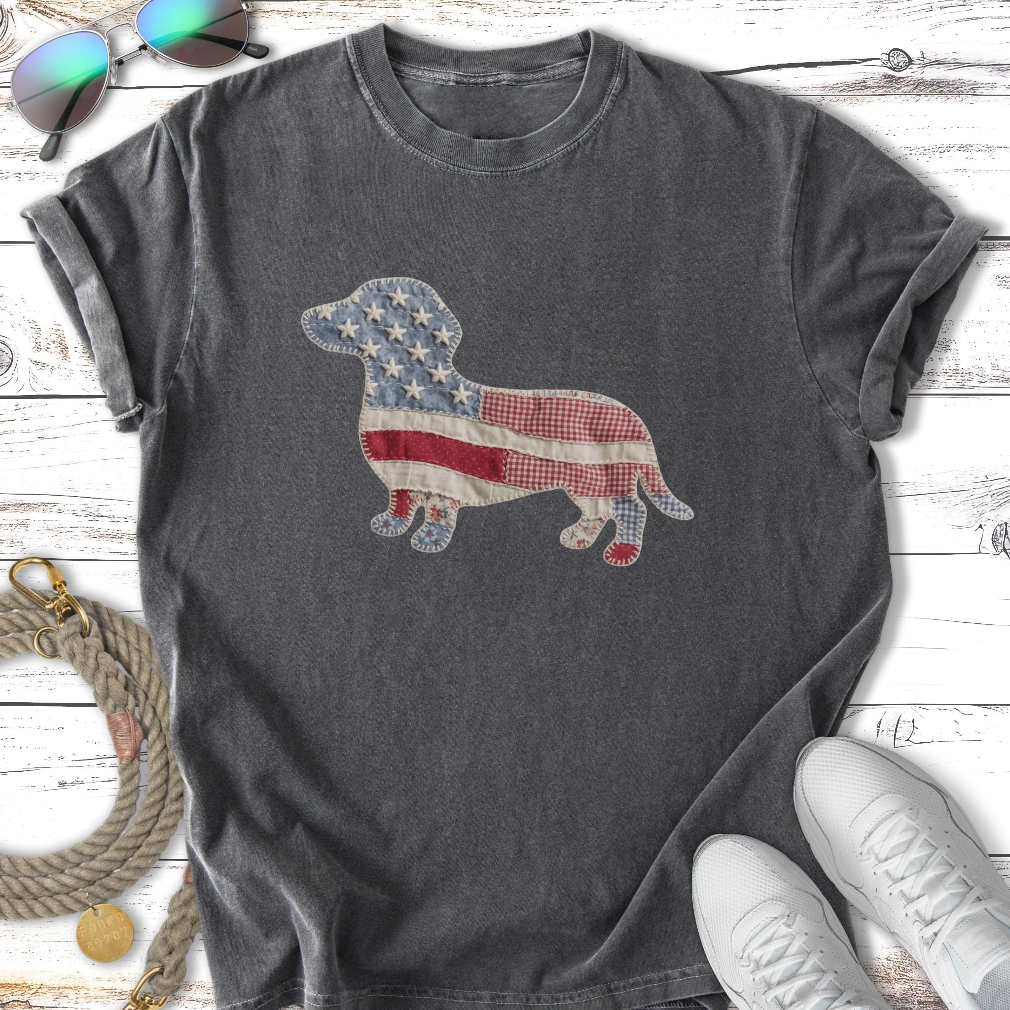 Dark t-shirt with patriotic dachshund patch, sunglasses, and sneakers.