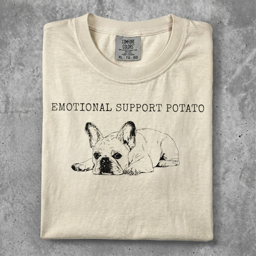 French bulldog graphic with "Emotional Support Potato" text on a cream t-shirt.