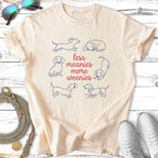 Cream t-shirt with dachshund illustrations and text "Less meanies more weenies".