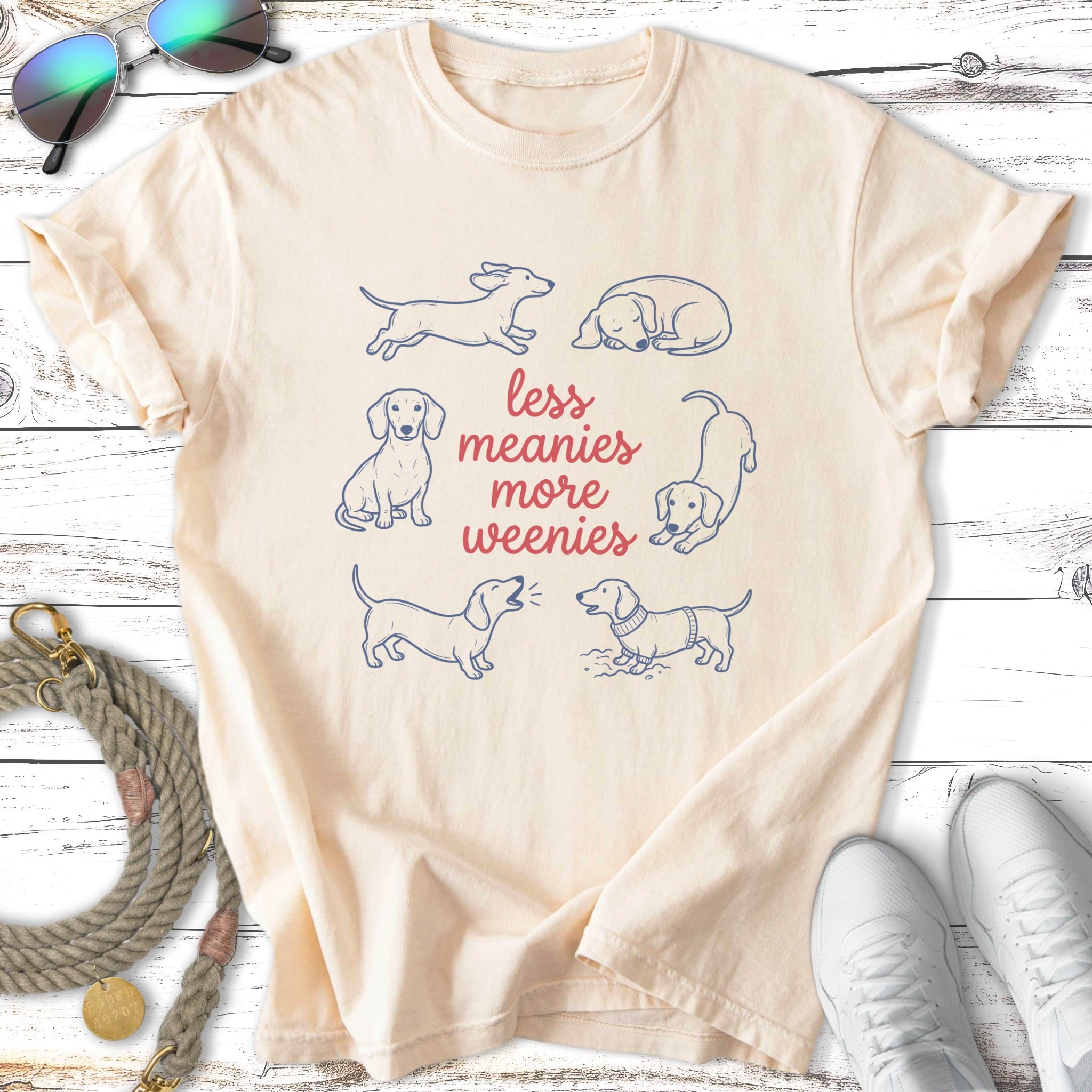 Cream t-shirt with dachshund illustrations and text "Less meanies more weenies".