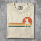 Cream t-shirt with vintage French bulldog silhouette and striped sunset graphic.
