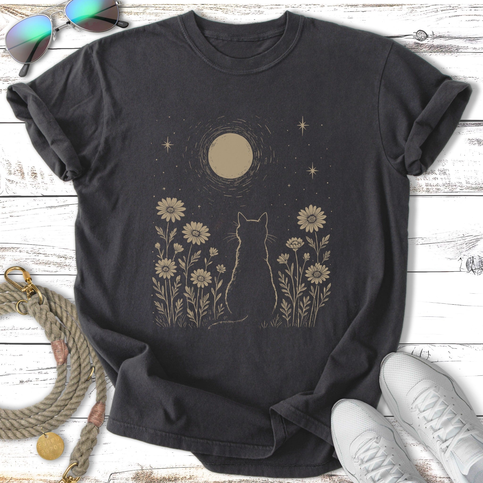 Dark t-shirt with celestial cat and floral design.