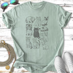 Grid of twelve small illustrated cats in different poses on a light green t-shirt.