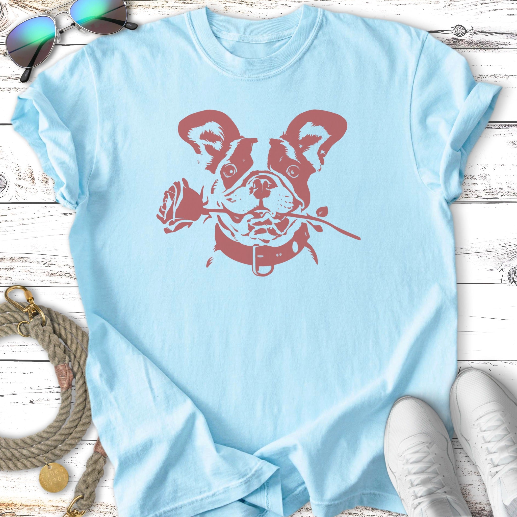 Light blue t-shirt with a French bulldog holding a rose in its mouth.