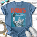 Blue t-shirt with "PAWS" in red letters above a cat reaching from water.