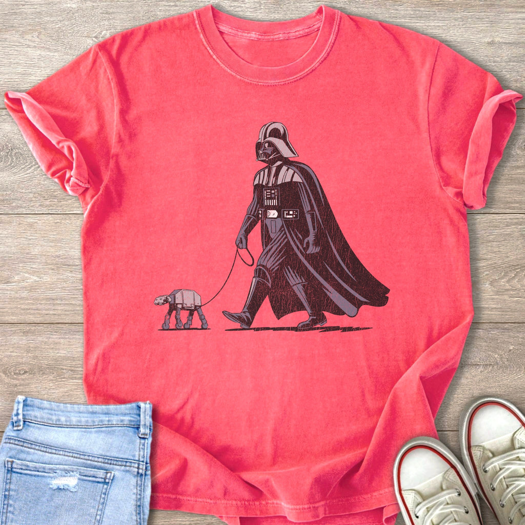 Darth Vader walks an AT-ST walker on a leash, shown on a pink t-shirt.