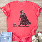 Darth Vader walks an AT-ST walker on a leash, shown on a pink t-shirt.
