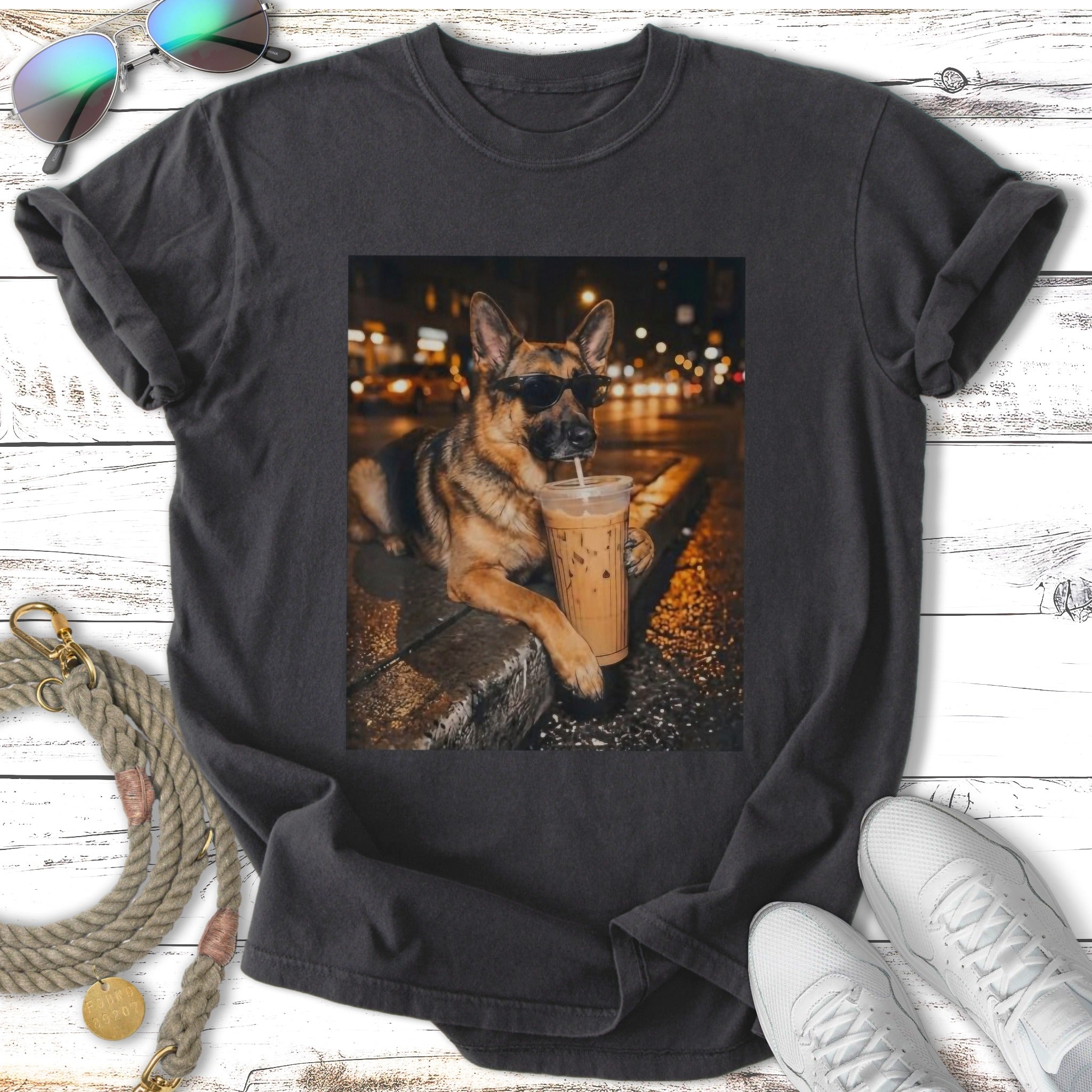 German Shepherd wearing sunglasses, holding an iced coffee cup.