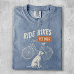 Blue t-shirt with "Ride Bikes Pet Dogs" text and a bicycle and dog graphic.
