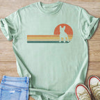 Light green t-shirt with distressed retro French Bulldog sunset graphic.
