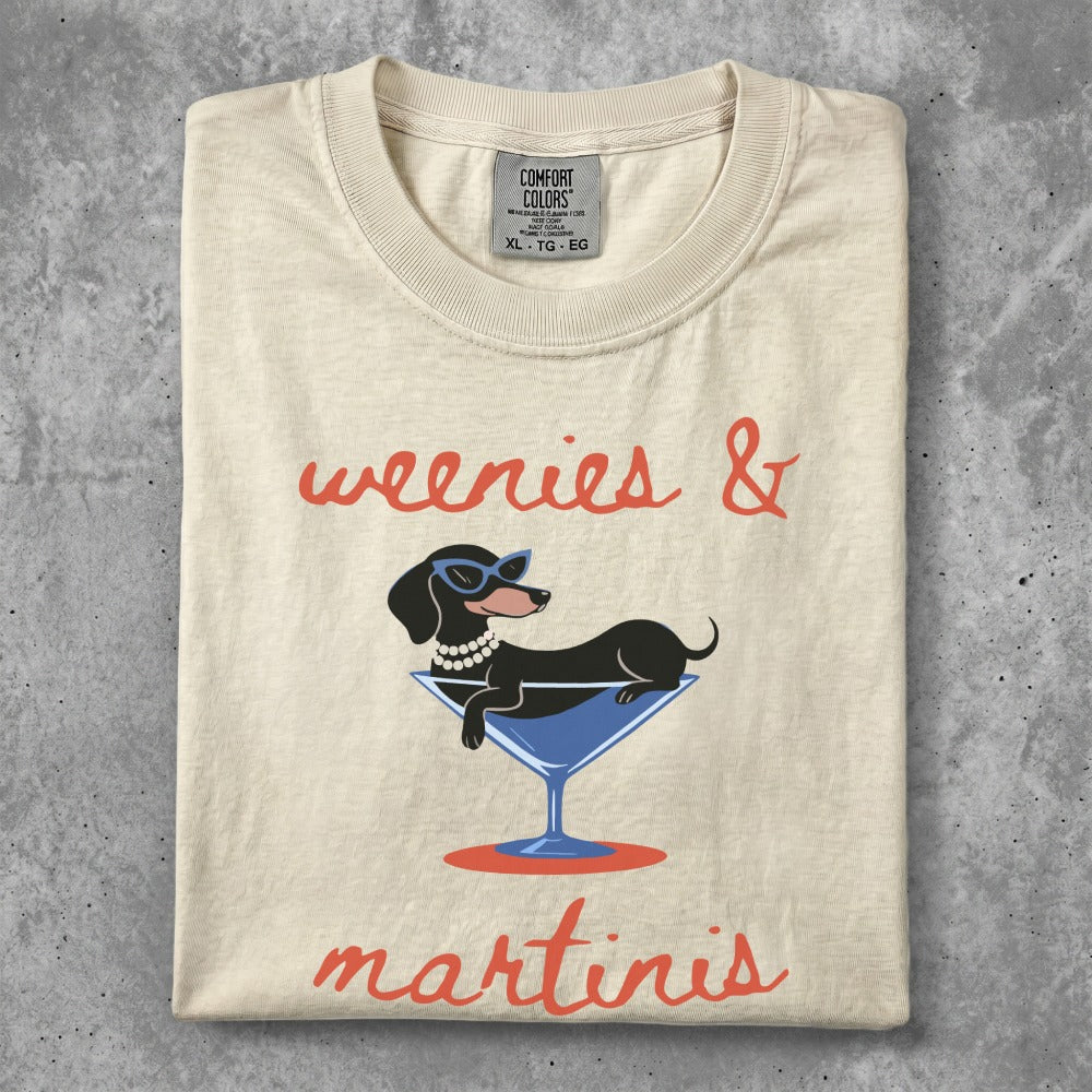 Dachshund wearing sunglasses in a martini glass, text reads "weenies & martinis".