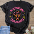 Dachshund wearing heart sunglasses with text "More Weenies Less Meanies."