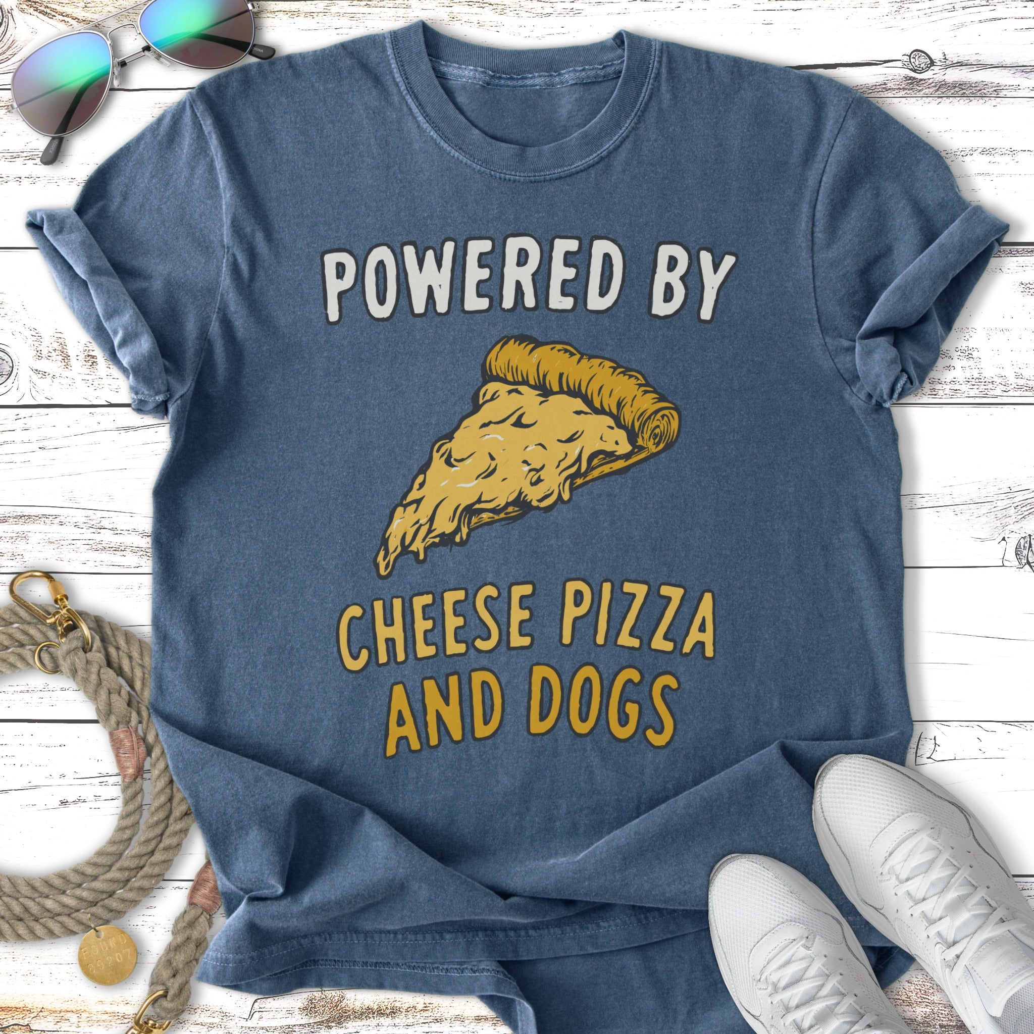 Blue t-shirt with yellow text "POWERED BY CHEESE PIZZA AND DOGS" and a pizza slice.