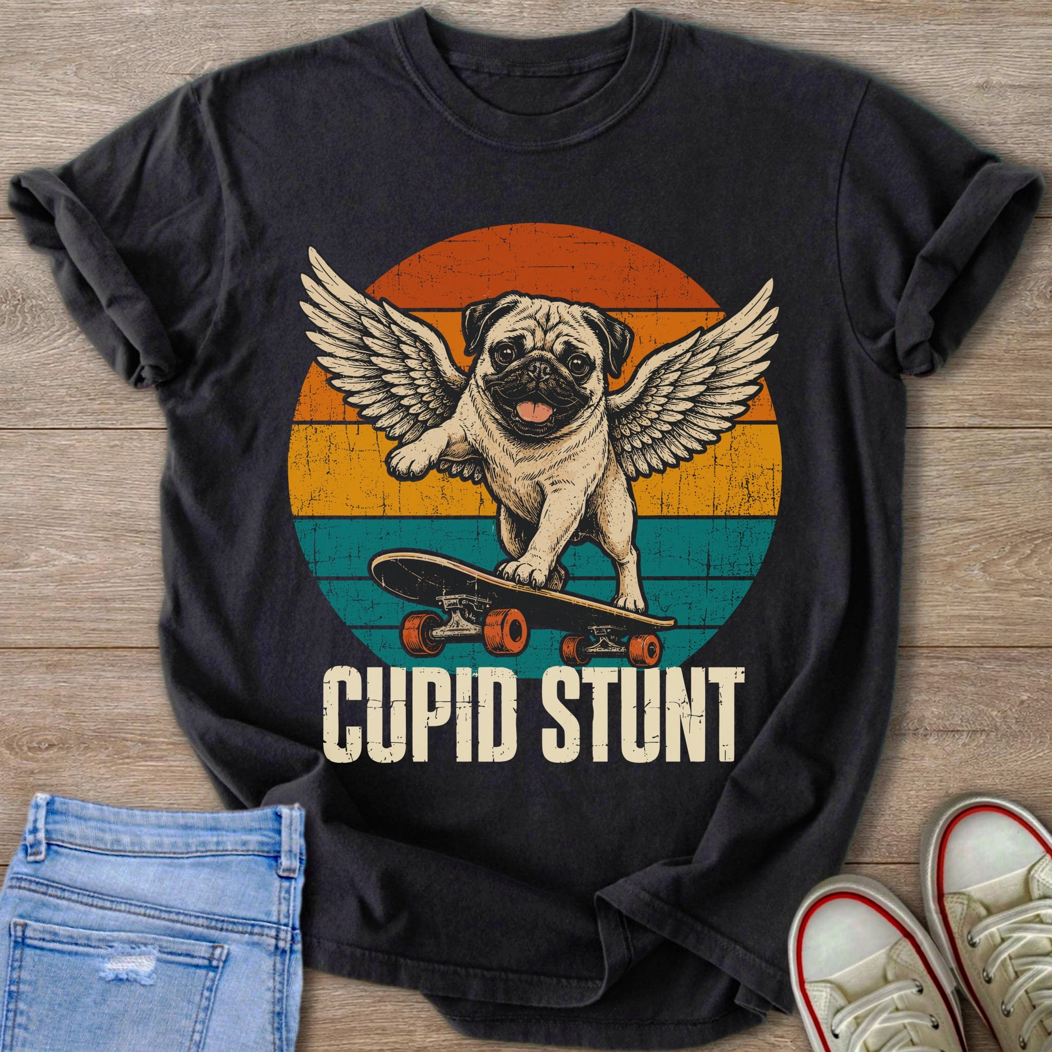 Winged pug on a skateboard with text "CUPID STUNT" and vintage sunset stripes.
