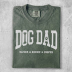Green t-shirt with "DOG DAD" text and paw print.