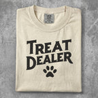 Cream t-shirt with "Treat Dealer" and a paw print graphic.