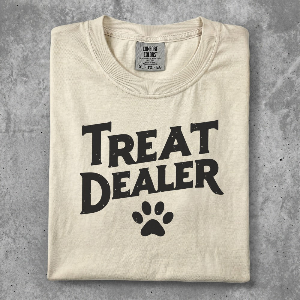 Cream t-shirt with "Treat Dealer" and a paw print graphic.