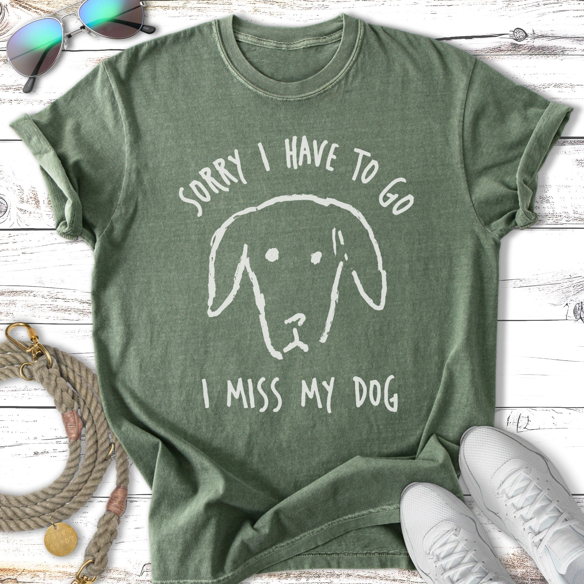 Green t-shirt with "Sorry I Have To Go, I Miss My Dog" and a dog illustration.