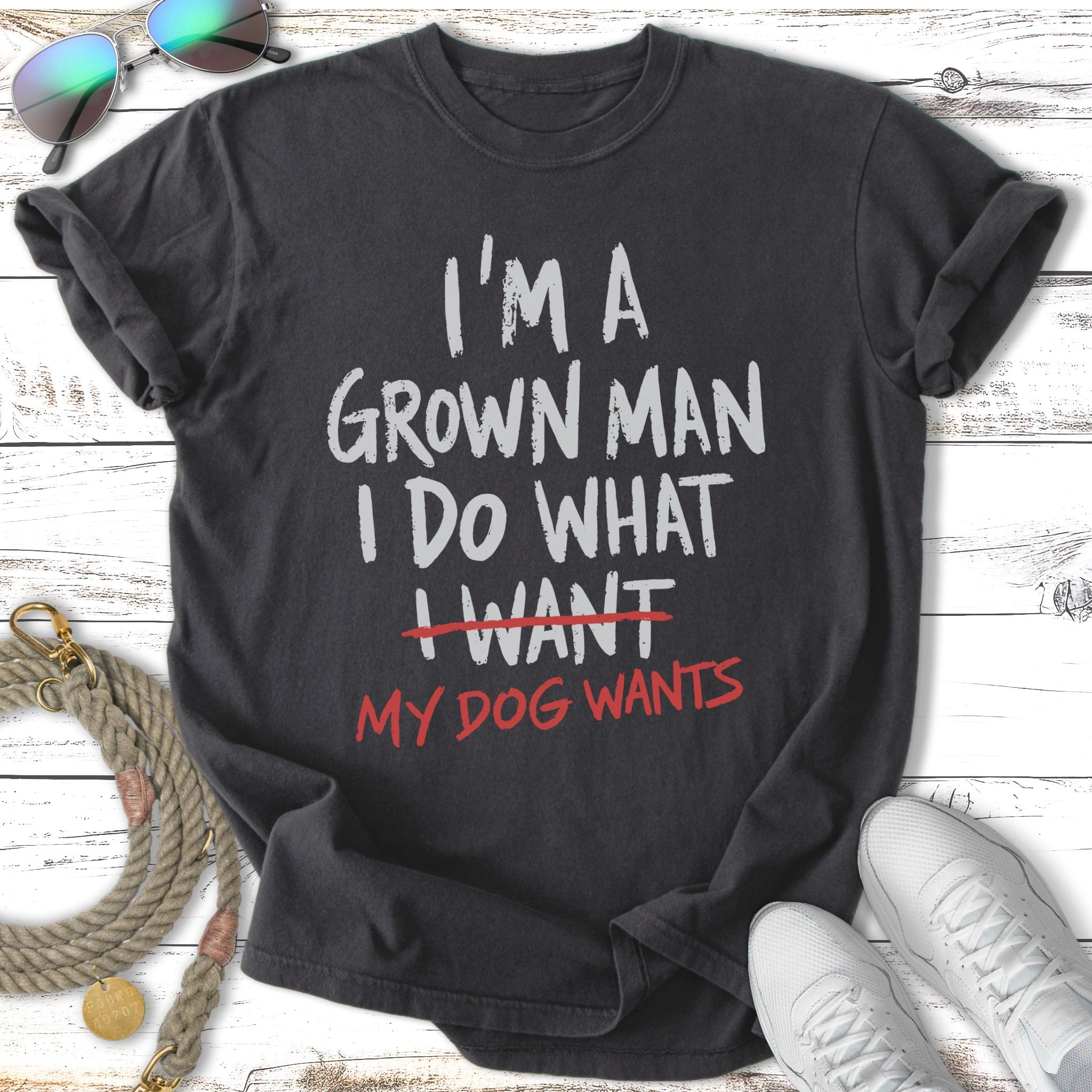 Black t-shirt with white text: "I'm a grown man I do what I want my dog wants."