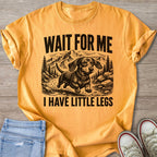 Orange t-shirt with black graphic of a dachshund and text "WAIT FOR ME I HAVE LITTLE LEGS".