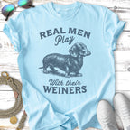 Light blue t-shirt with a dachshund and text "REAL MEN Play WITH THEIR WEINERS".