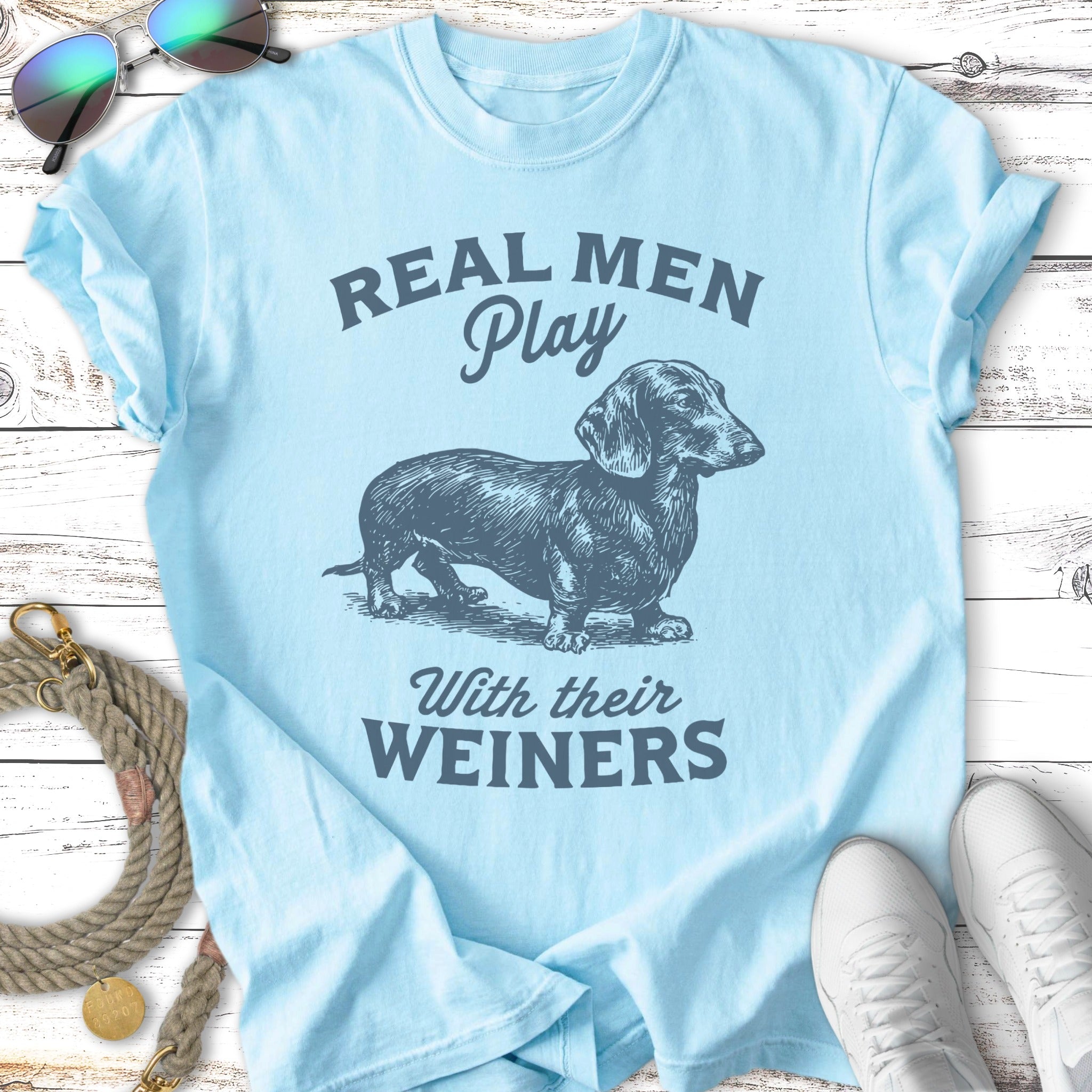Light blue t-shirt with a dachshund and text "REAL MEN Play WITH THEIR WEINERS".