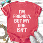 Coral t-shirt with white text "I'm Friendly, But My Dog Isn't".