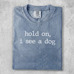 Blue t-shirt with "hold on, i see a dog" text.