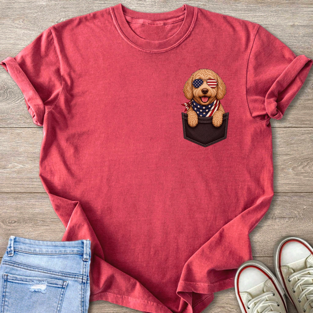 Red t-shirt with a cartoon dog wearing American flag sunglasses and bandana in a pocket.