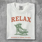 White t-shirt with "RELAX" and dog on a lounge chair graphic.
