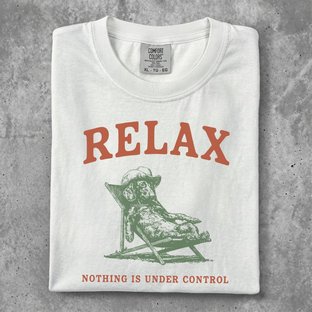 White t-shirt with "RELAX" and dog on a lounge chair graphic.