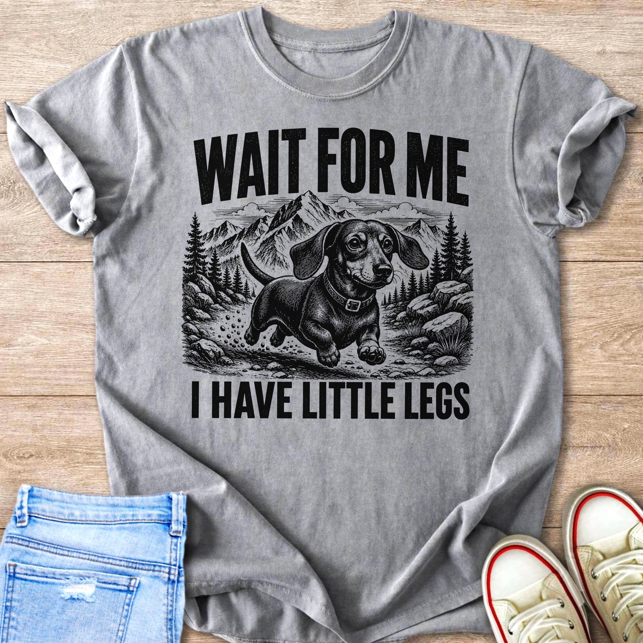 Gray t-shirt with dachshund and mountains graphic, reads "WAIT FOR ME I HAVE LITTLE LEGS".