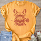 French bulldog with a rose in its mouth on an orange t-shirt.