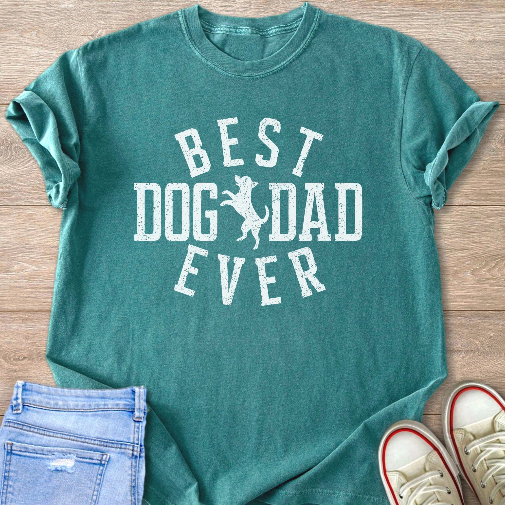Teal t-shirt with white distressed text reading "BEST DOG DAD EVER" and a dog silhouette.