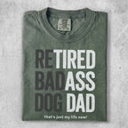 Green t-shirt with "RETIRED BADASS DOG DAD that's just my life now!" text.