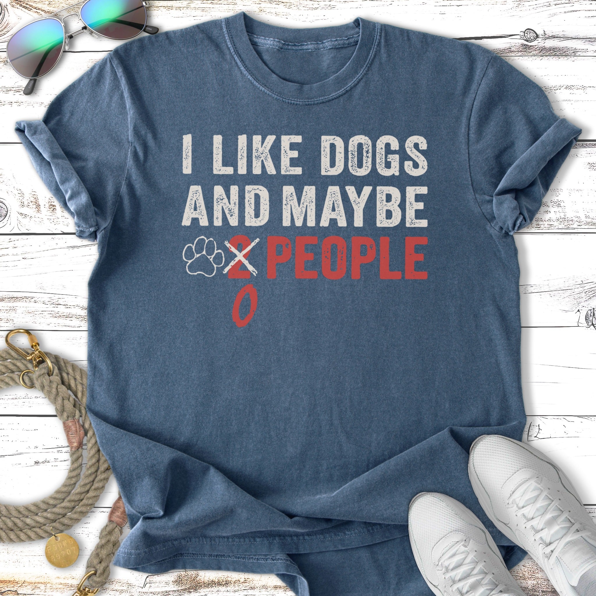 Blue t-shirt with white text "I LIKE DOGS AND MAYBE 2 PEOPLE" and a red paw print.