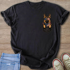 German Shepherd wearing American flag bandana and sunglasses peeking from a pocket.