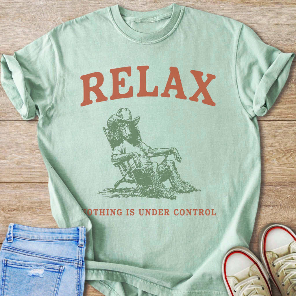 Mint t-shirt with "RELAX" and a poodle in a cowboy hat sitting in a chair.