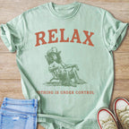 Mint t-shirt with "RELAX" and a poodle in a cowboy hat sitting in a chair.