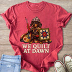 Red t-shirt with dachshund in armor holding a seam ripper, a quilt shield, and text "We Quilt at Dawn".