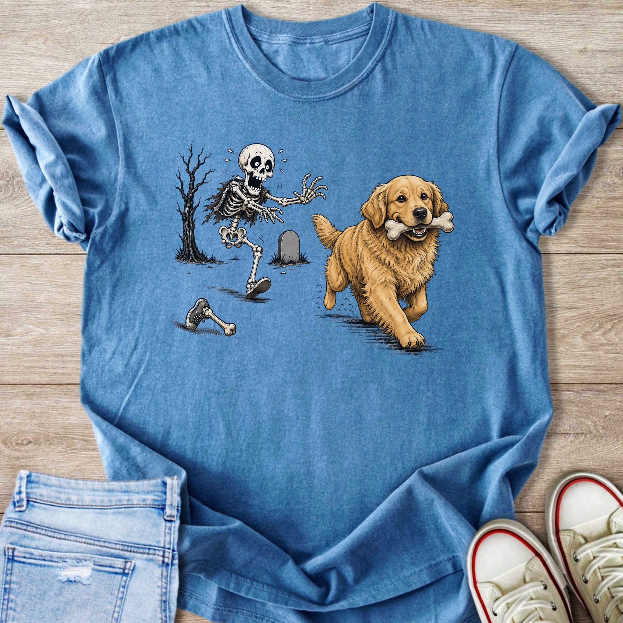 Golden retriever carries bone past worried skeleton near tombstone and bare tree.