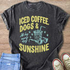 T-shirt with "Iced coffee, dogs & sunshine" text, iced drink, glasses, and paw prints.