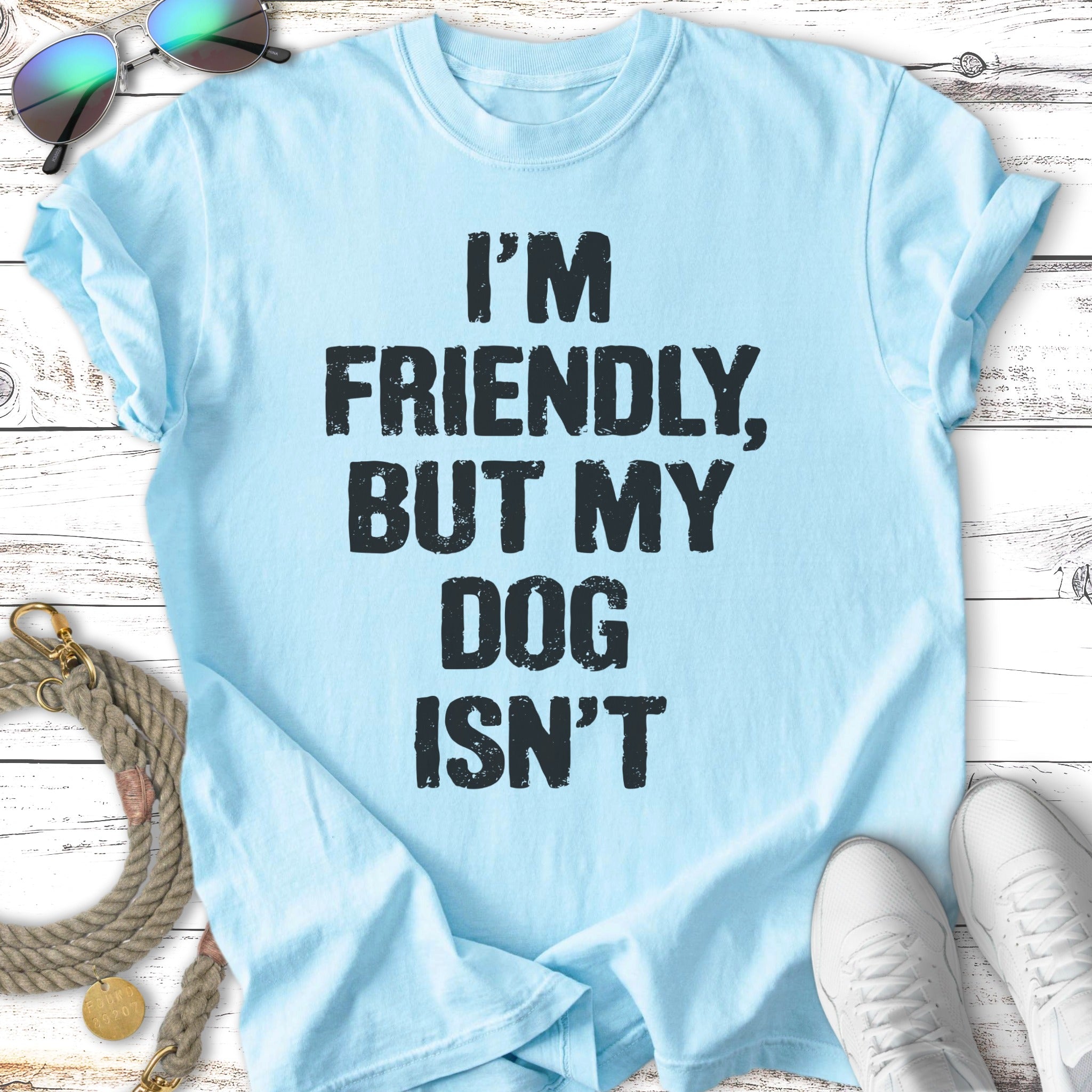 Light blue t-shirt with "I'M FRIENDLY, BUT MY DOG ISN'T" text.
