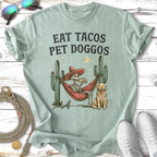 Skeleton in hammock eating tacos with dog and cactus.