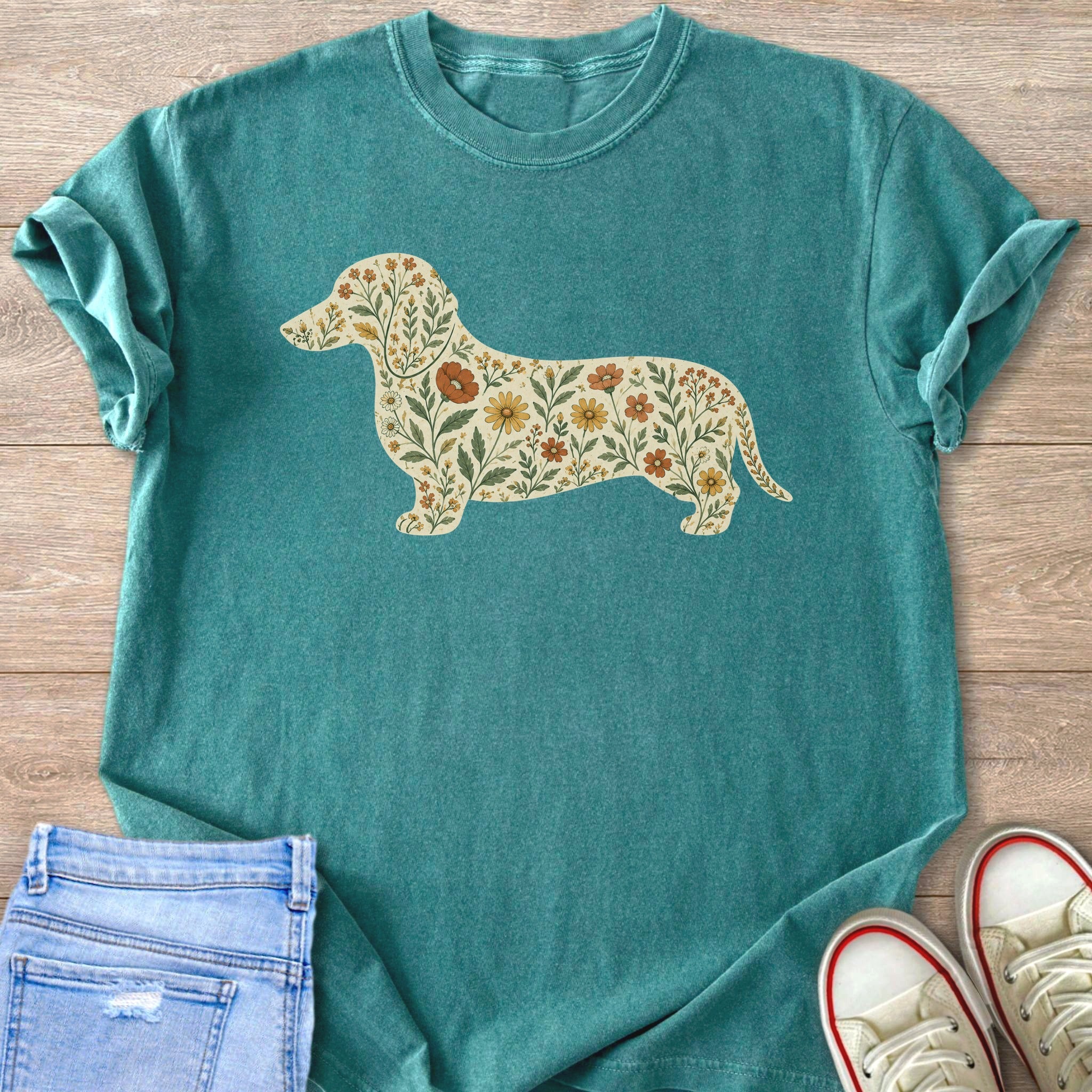 Teal t-shirt with a silhouette of a dachshund filled with a floral pattern.